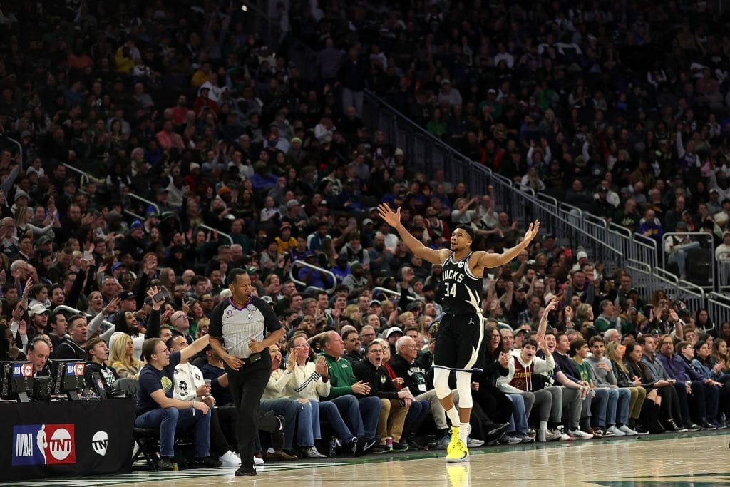 Giannis Antetokounmpo #34 of the Milwaukee Bucks reacts to a three point shot during the second half of a game against the Golden State Warriors at Fiserv Forum on December 13, 2022 in Milwaukee, Wisconsin.