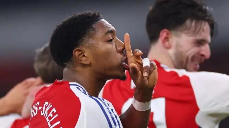 Miles Lewis-Skelly joins the celebrations after Leandro Trossard gives Arsenal the lead against Tottenham at Emirates Stadium

