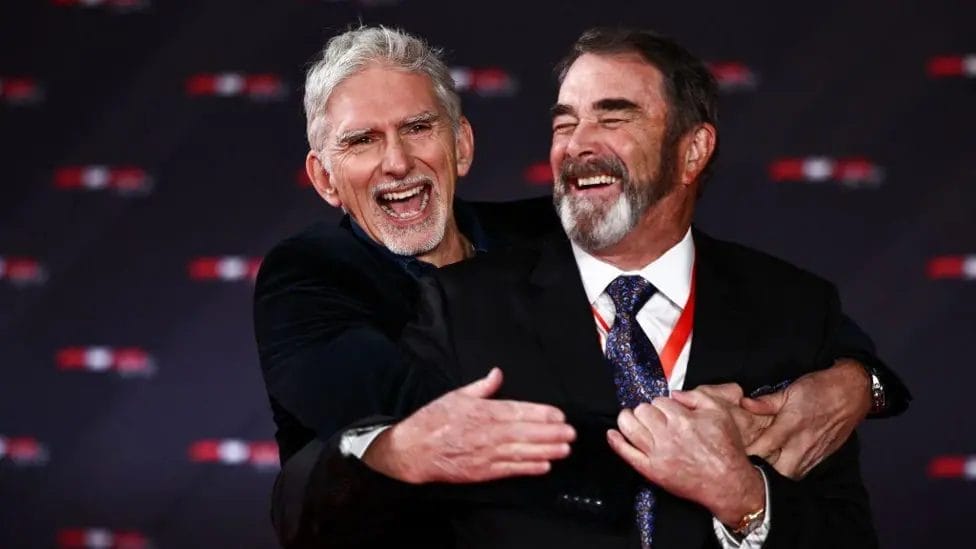 Damon Hill and Nigel Mansell - world champions in 1996 and 1992 respectively - share a laugh together on the red carpet

