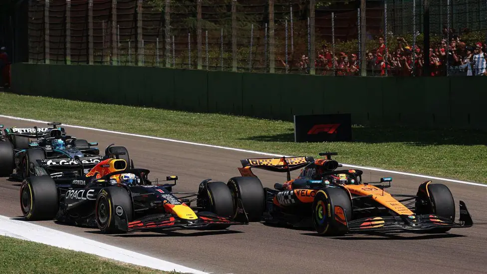 Max Verstappen moves alongside Oscar Piastri as they approach the Tamburello chicane